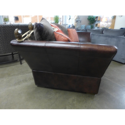 1305 - A designer Knowle leather drop arm sofa retailed in Barker & Stonehouse