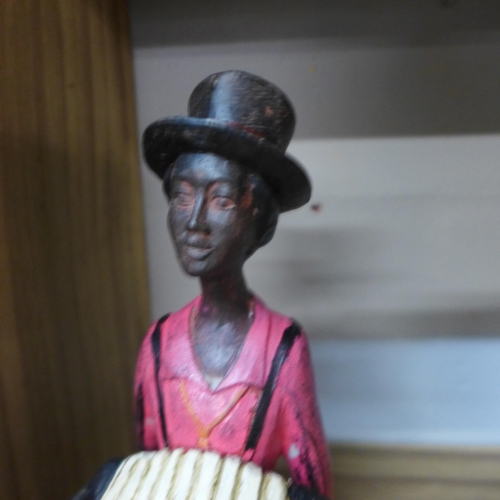 1412 - A sitting jazz band squeeze box player, 40cms (026312)   #