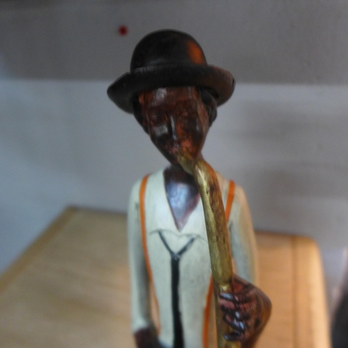 1413 - A sitting jazz band saxophonist, 38cms (026011)   #