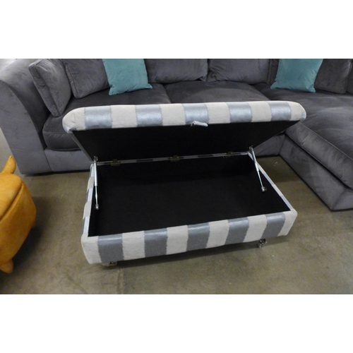 1430 - A blue and grey striped upholstered storage footstool