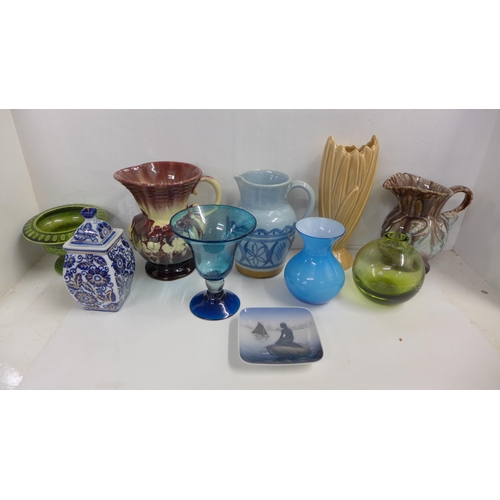 1186 - A collection of jugs and vases including a Sylvac vase, a stoneware jug, a Holkham stand, glass vase... 