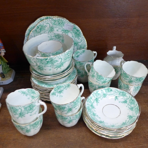 677 - A circa 1900 tea service, eleven cups, eleven saucers, eleven side plates, cream, sugar and two sand... 