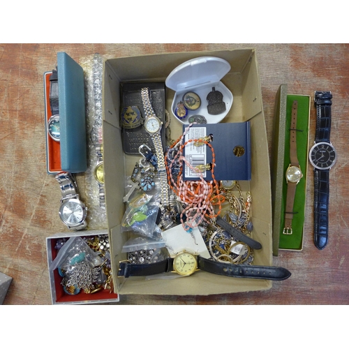 681 - A collection of wristwatches and brooches and a silver ARP badge, etc.