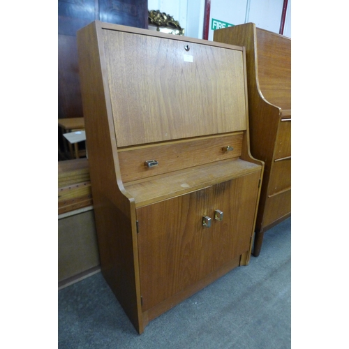 105 - A teak bureau and a chest of drawers