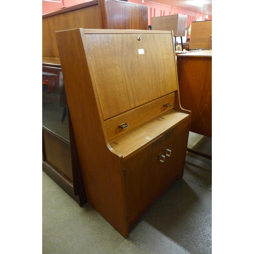 105 - A teak bureau and a chest of drawers