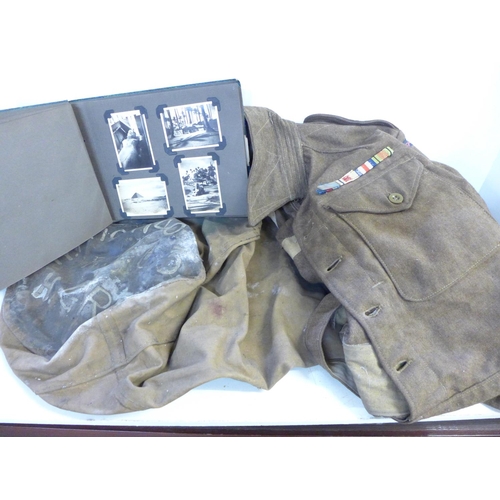 755 - An Army uniform and kit bag and an album of phographs taken whilst on active service in North Africa