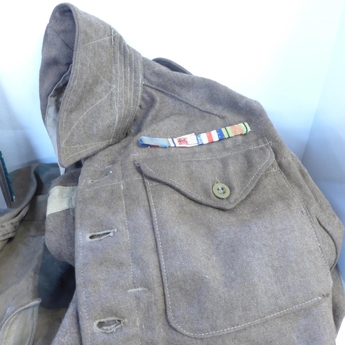 755 - An Army uniform and kit bag and an album of phographs taken whilst on active service in North Africa