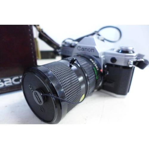 773 - A Canon AE-1 camera with box and accessories including lenses, filters, etc.