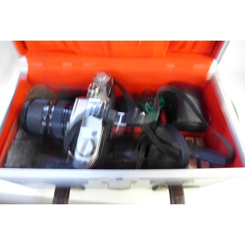 773 - A Canon AE-1 camera with box and accessories including lenses, filters, etc.