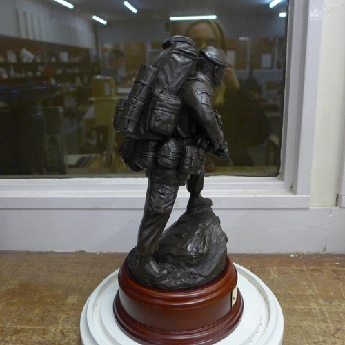 786 - A resin model of a Royal Marine on a wooden plinth with plaque under a glass dome, dome 36cm