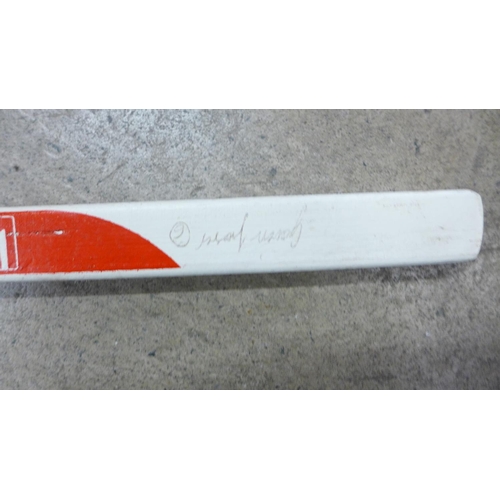 805 - A signed Koho ice hockey stick with two pucks