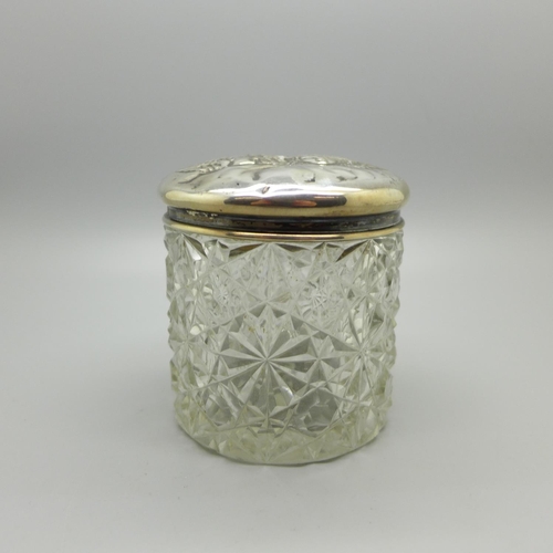 829 - A silver topped cut glass jar decorated with Reynolds angels, Birmingham 1904