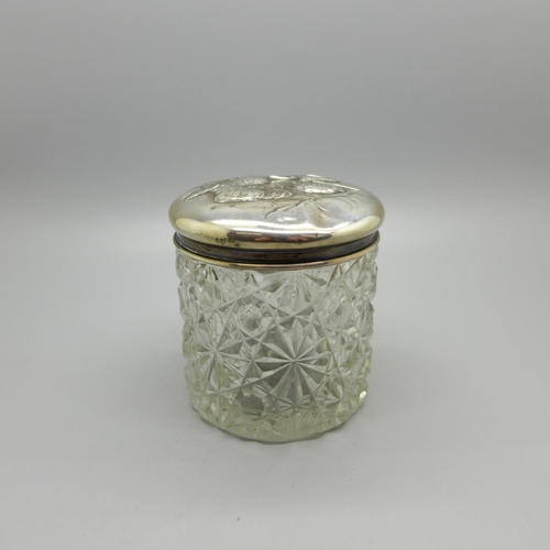 829 - A silver topped cut glass jar decorated with Reynolds angels, Birmingham 1904
