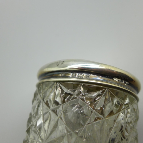 829 - A silver topped cut glass jar decorated with Reynolds angels, Birmingham 1904