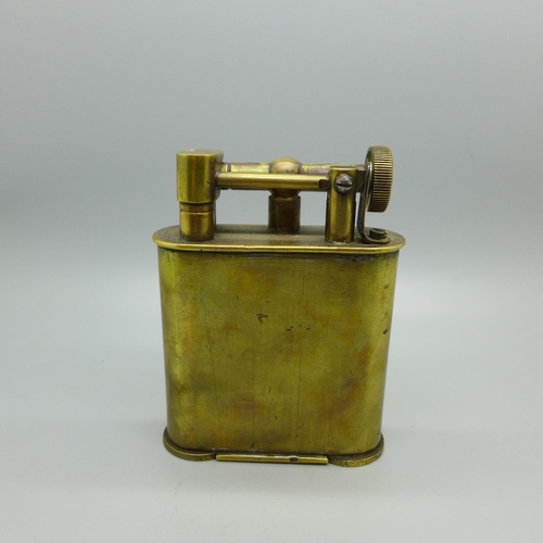 830 - An early 20th Century brass table lighter mounted with Totenkopf head, skull and crossbones or 'deat... 