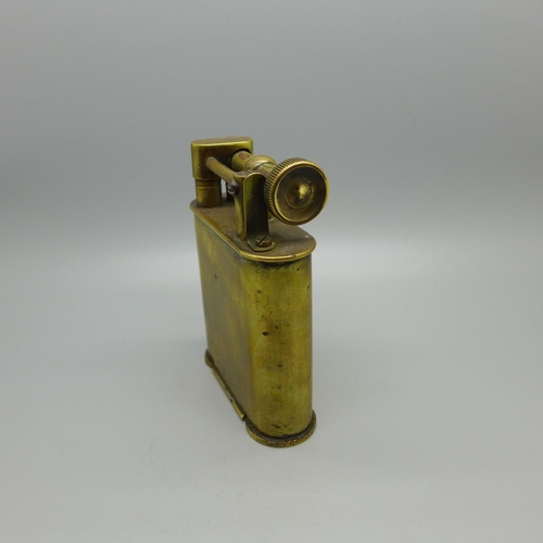 830 - An early 20th Century brass table lighter mounted with Totenkopf head, skull and crossbones or 'deat... 