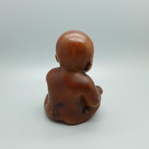 833 - A Chinese carved wooden figure of an infant, height 94mm
