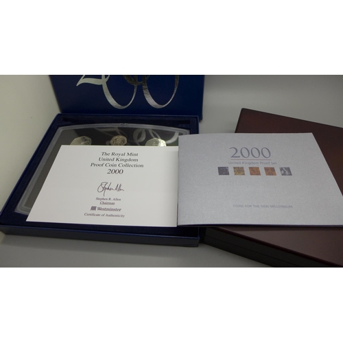 851 - A Royal Mint UK proof coin collection 2000 and a Westminster The Queen's New Portrait Specimen Set, ... 