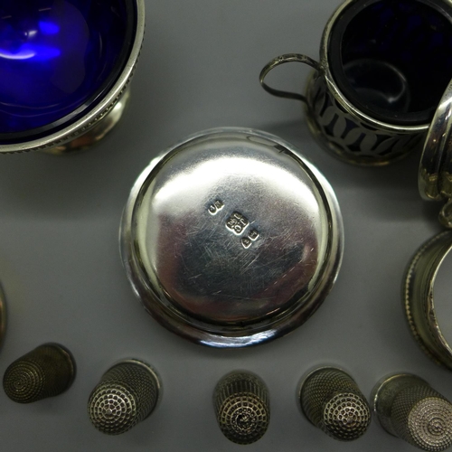 856 - Five silver thimbles including two Charles Horner, a silver salt and mustard, a silver burner, etc.,... 