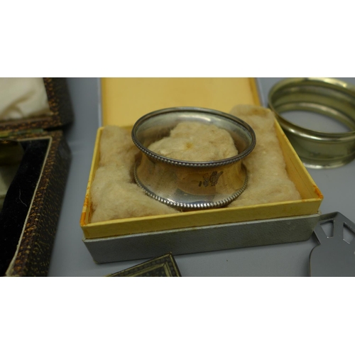 923 - A pair of Art Deco silver napkin rings by Walker & Hall, cased, one other silver napkin ring, etc.