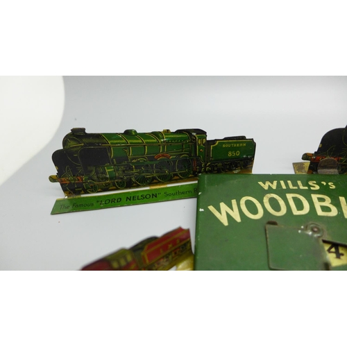 933 - A tin-plate Wills's Woodbine Cricket Game and four tin-plate locomotive plaques