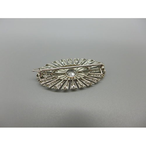 955 - An Art Deco diamond brooch, set with 126 diamonds, Millennium setting, centre stone 1ct diamond weig... 