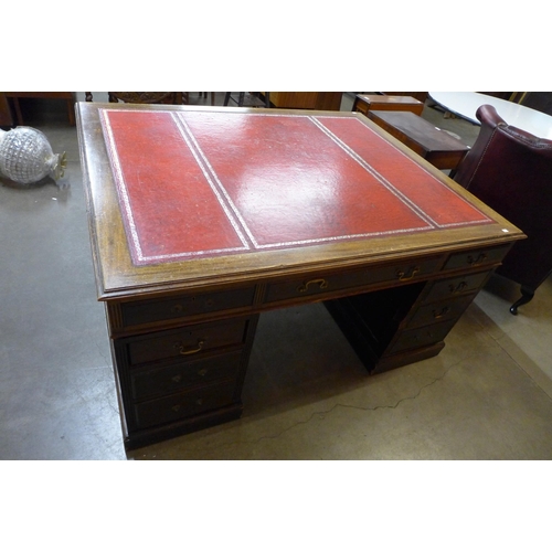 41 - A George III style mahogany and red leather topped partners desk