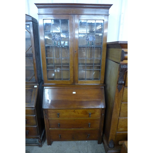 120 - An Arts and Crafts walnut bureau bookcase