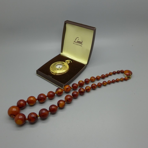 1180 - A string of beads and a Limit pocket watch, cased