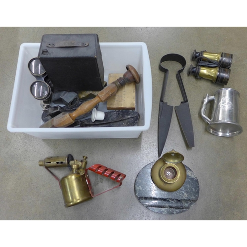 1215 - A collection of metal ware including binoculars, a camera, a military engraved pewter mug, a blow la... 