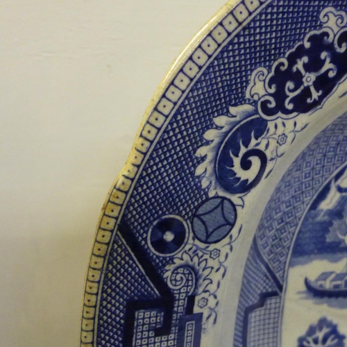 606 - A large blue and white Willow pattern meat plate