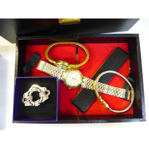 683 - A collection of costume jewellery including brooches and wristwatches in a jewellery box