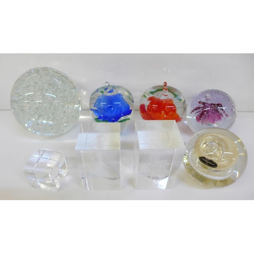 714 - A collection of eight glass paperweights