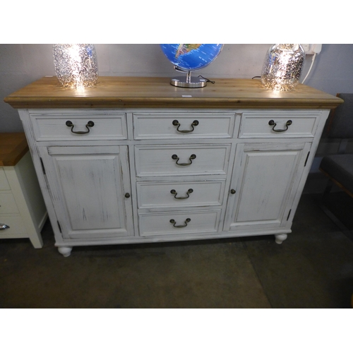 1333 - A rustic white painted two door six drawer sideboard, repair to front right leg