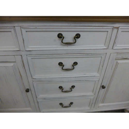 1333 - A rustic white painted two door six drawer sideboard, repair to front right leg