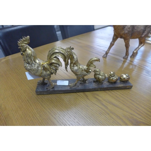 1399 - A chicken evolution gold sculpture, H 17cms x W 34cms (707611)   #