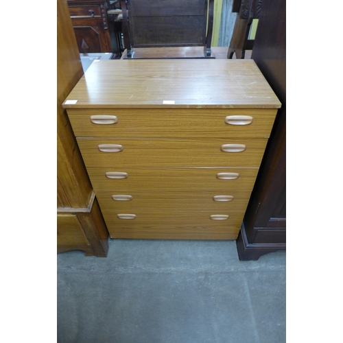 100 - A simulated teak chest of drawers