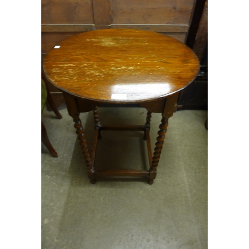 124 - An oak barleytwist circular occasional table