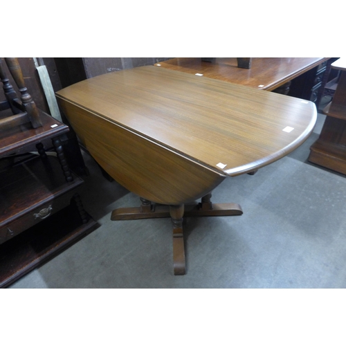 129 - An Ercol Golden Dawn elm and beech drop-leaf table