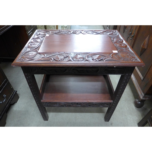 133 - A carved hardwood side table