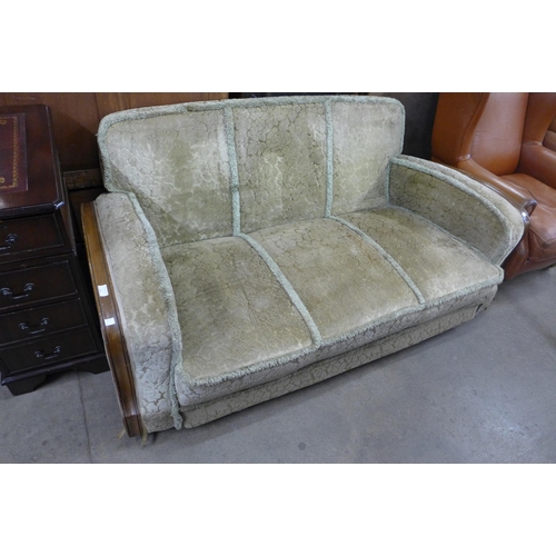 136 - An Art Deco walnut and fabric upholstered settee