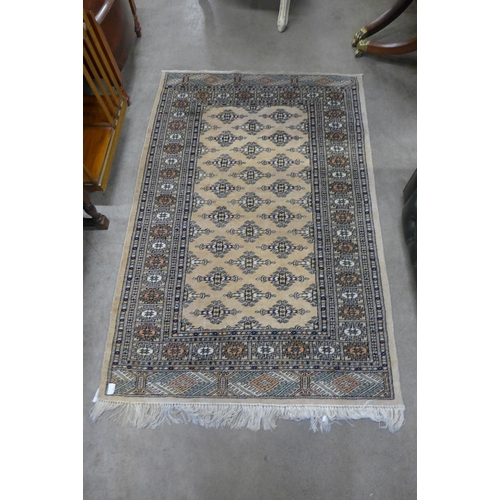 146 - A cream ground rug