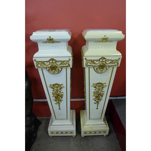 28 - A pair of French Louis XV style cream and parcel gilt jardiniere stands, 125cms h