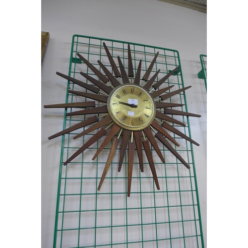 366 - A teak and brass sunburst wall clock