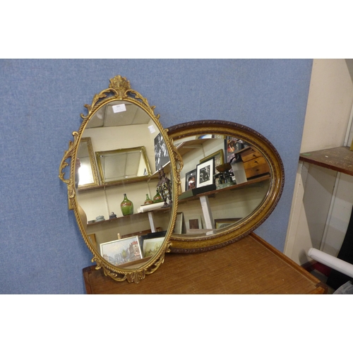 383 - A simulated oak oval mirror and a gilt framed mirror