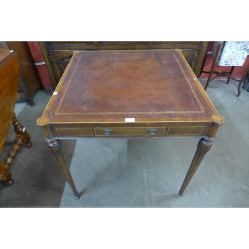 46 - An American inlaid mahogany and leather topped two drawer writing table