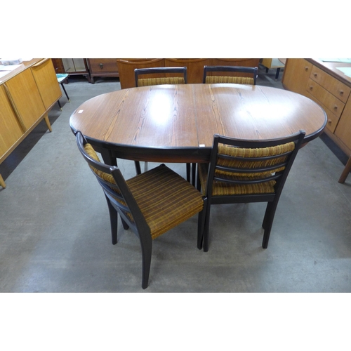 73 - A teak extending dining table and four chairs