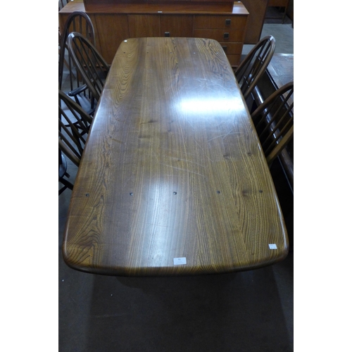 91 - An Ercol Golden Dawn elm and beech refectory table and six Quaker chairs