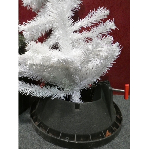 3268 - Two plastic tree bases and a Christmas tree tops