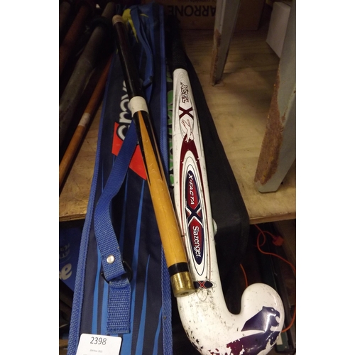 2398 - 2 Hockey sticks in bags sold with a pool cue